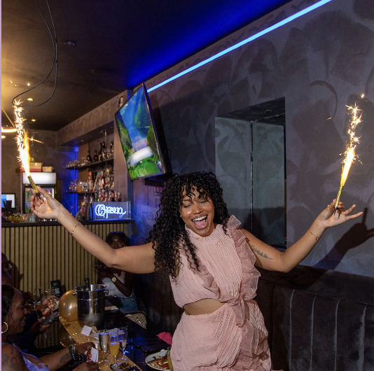 Photo from an event where the CEO is holding sparklers and laughing
