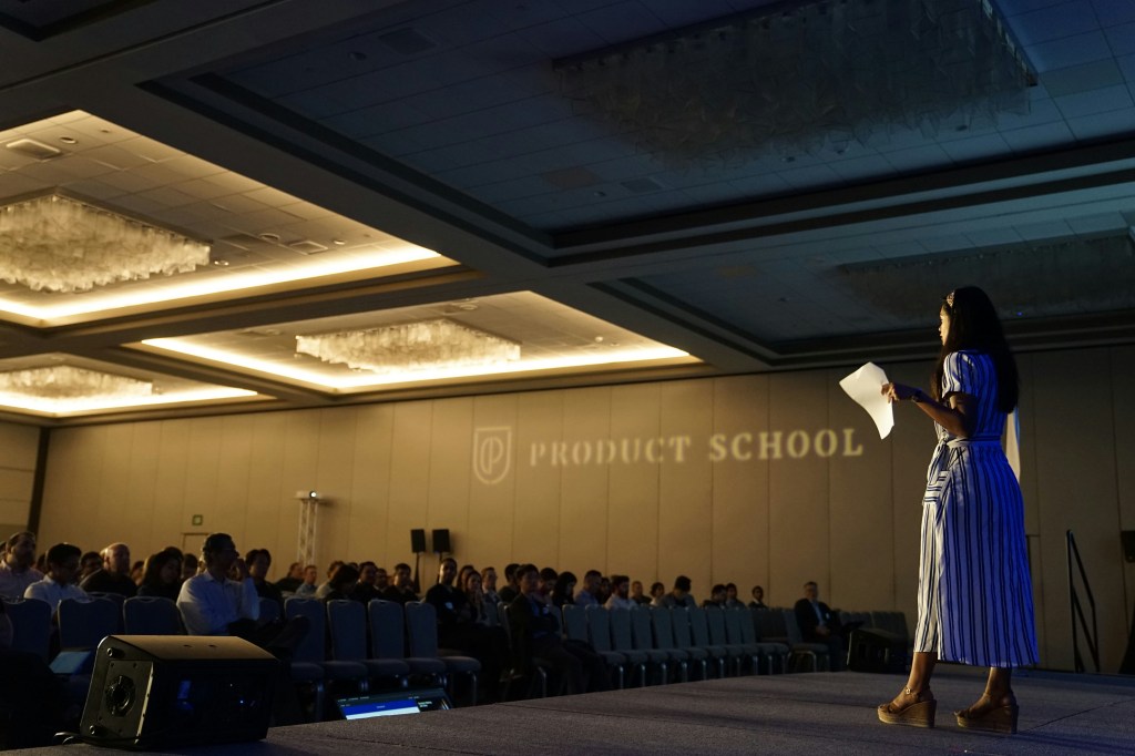 photo of a woman talking on a stage